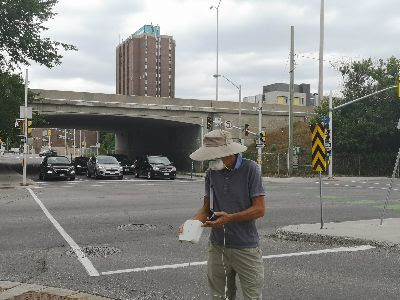 Project Lead Jake Cole using an air quality monitor in Ottawa